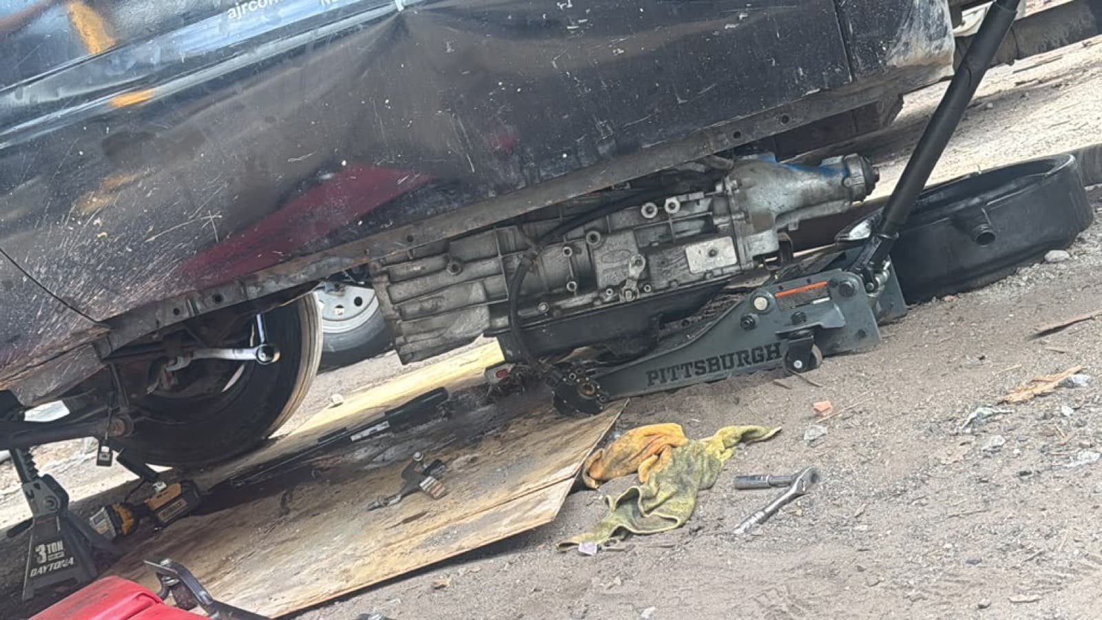 Transmission lowered out of a vehicle on a floor jack
