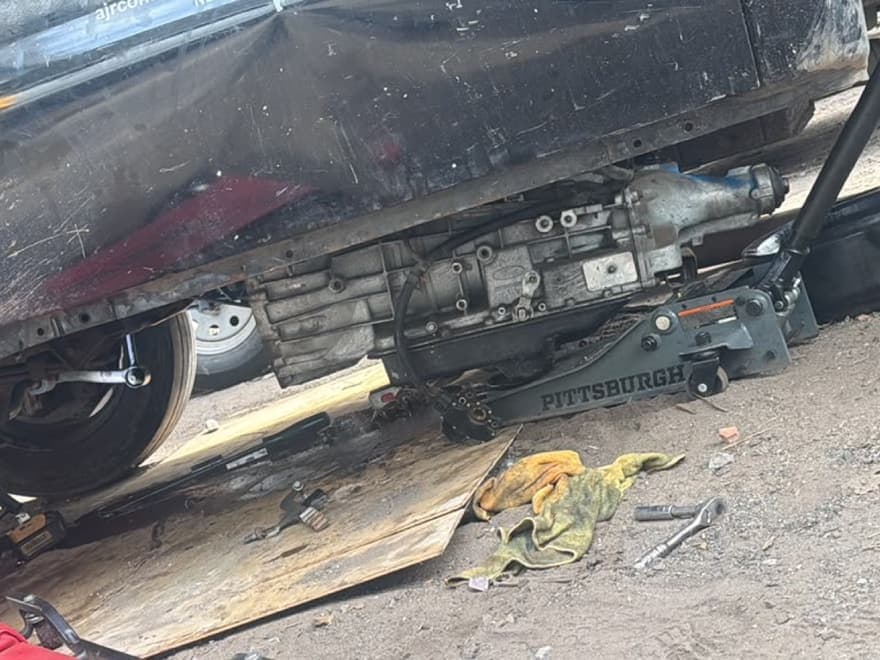 Transmission lowered out of a vehicle on a floor jack